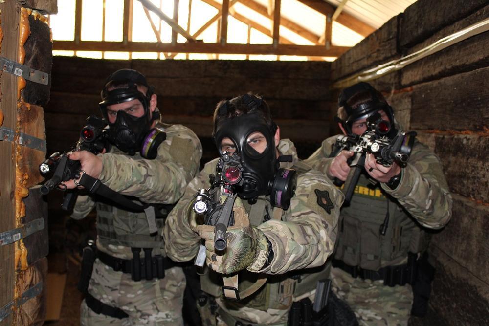 Special Responsce Team with gas masks and guns drawn