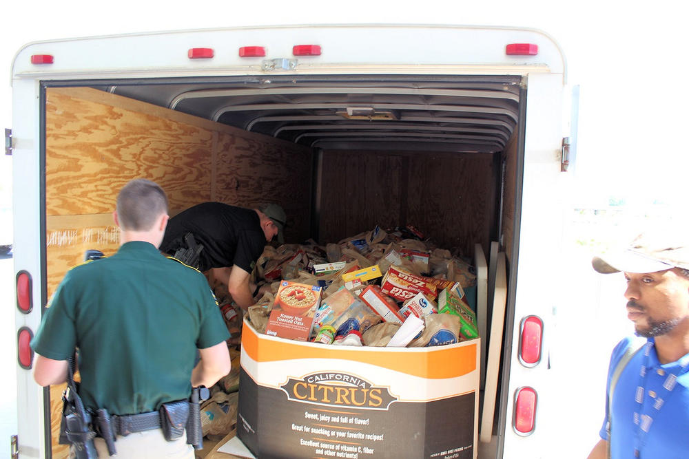 Swan and Watson loading the trailer with Kroger employees.JPG